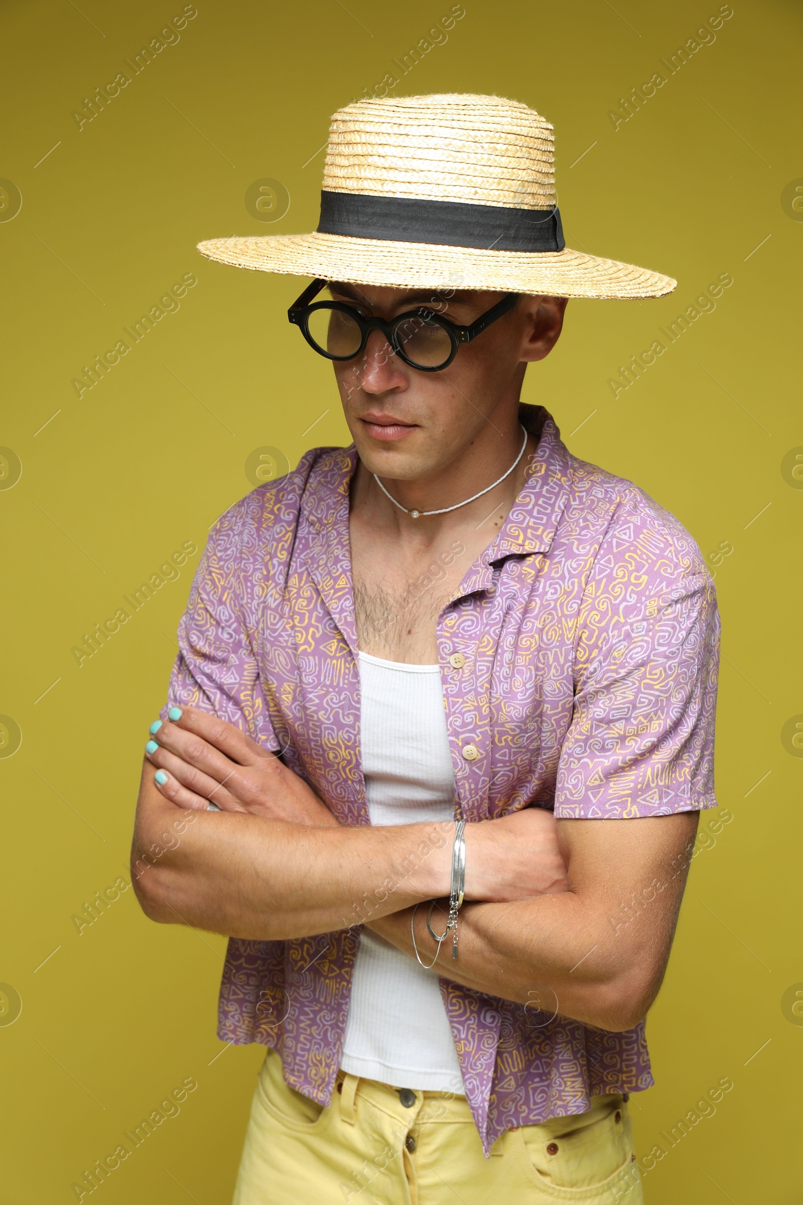 Fashionable portrait of handsome man in stylish outfit on yellow background Photo of Fashionable portrait of handsome man in stylish outfit on yellow background