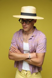 Photo of Fashionable portrait of handsome man in stylish outfit on yellow background