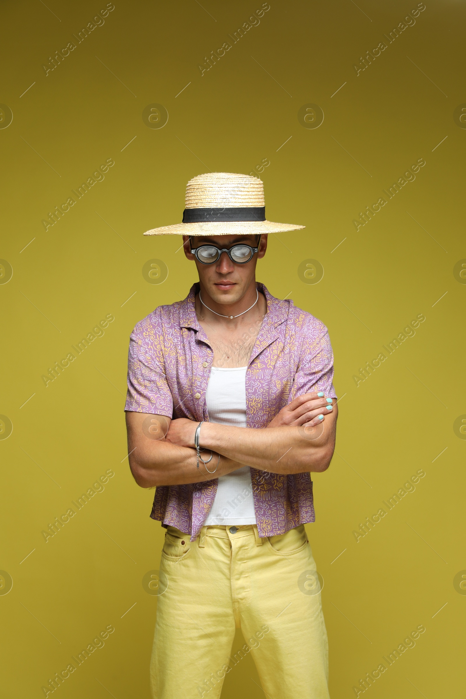 Fashionable portrait of handsome man in stylish outfit on color background Photo of Fashionable portrait of handsome man in stylish outfit on color background