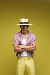 Photo of Fashionable portrait of handsome man in stylish outfit on color background
