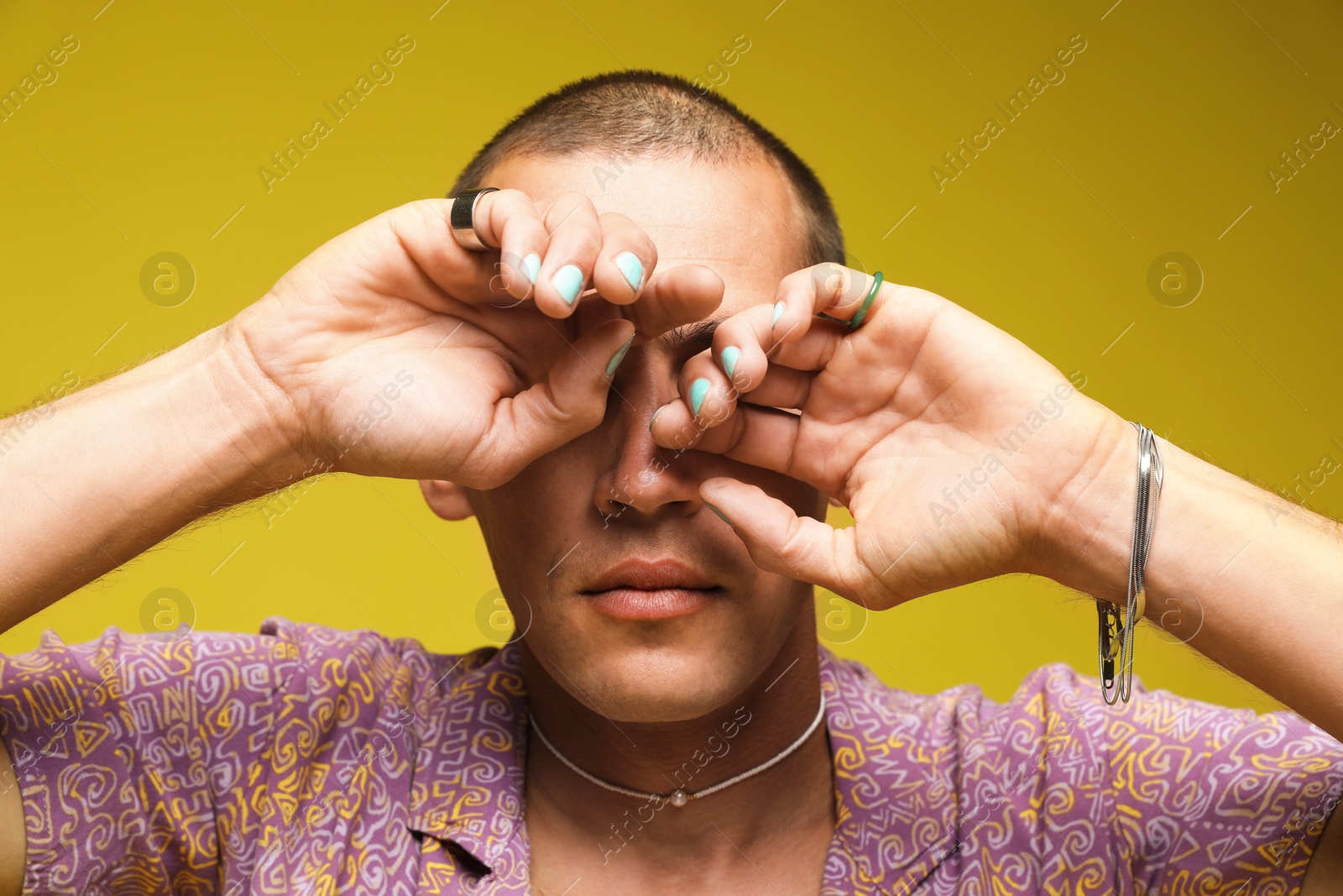 Fashionable portrait of handsome man in stylish outfit on yellow background Photo of Fashionable portrait of handsome man in stylish outfit on yellow background
