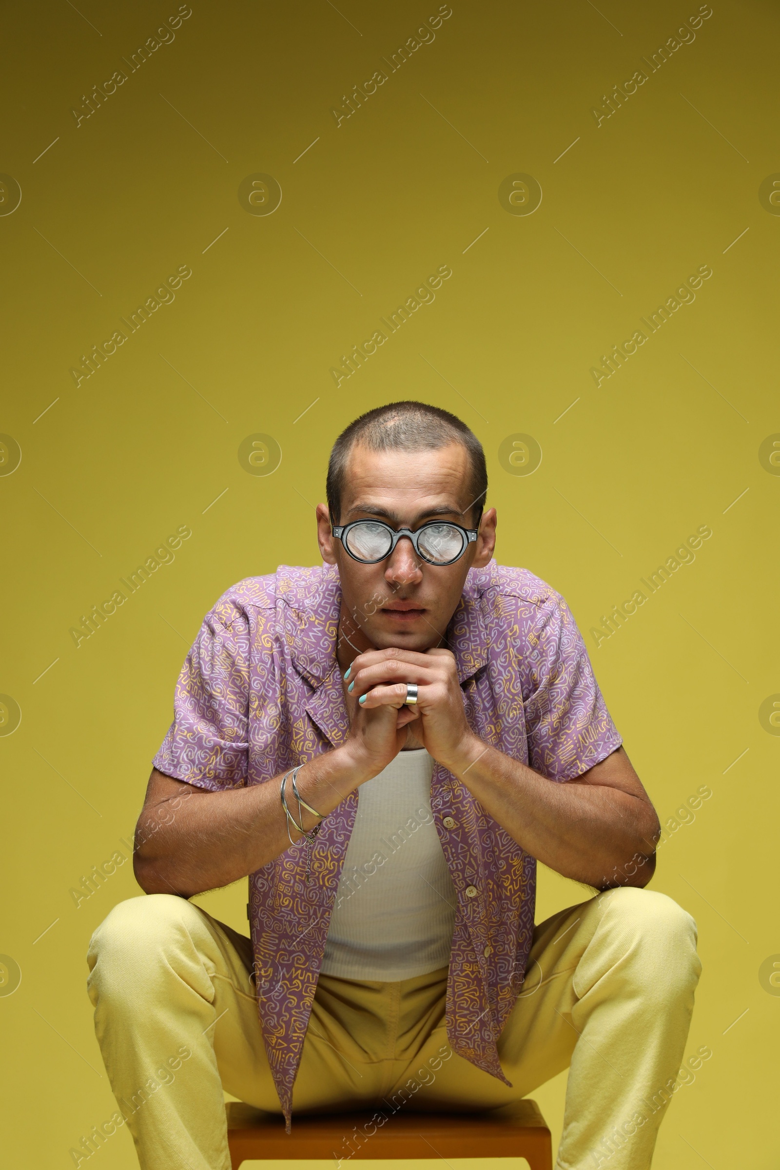 Fashionable portrait of handsome man in stylish outfit on color background Photo of Fashionable portrait of handsome man in stylish outfit on color background