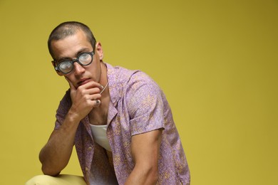 Photo of Fashionable portrait of handsome man in stylish outfit on color background, space for text