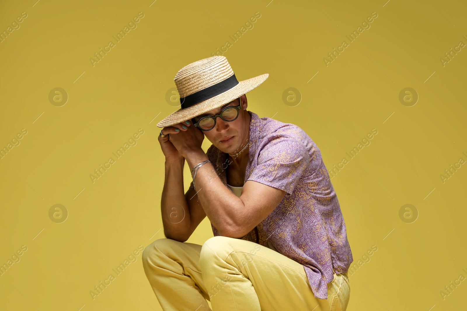 Fashionable portrait of handsome man in stylish outfit on color background Photo of Fashionable portrait of handsome man in stylish outfit on color background