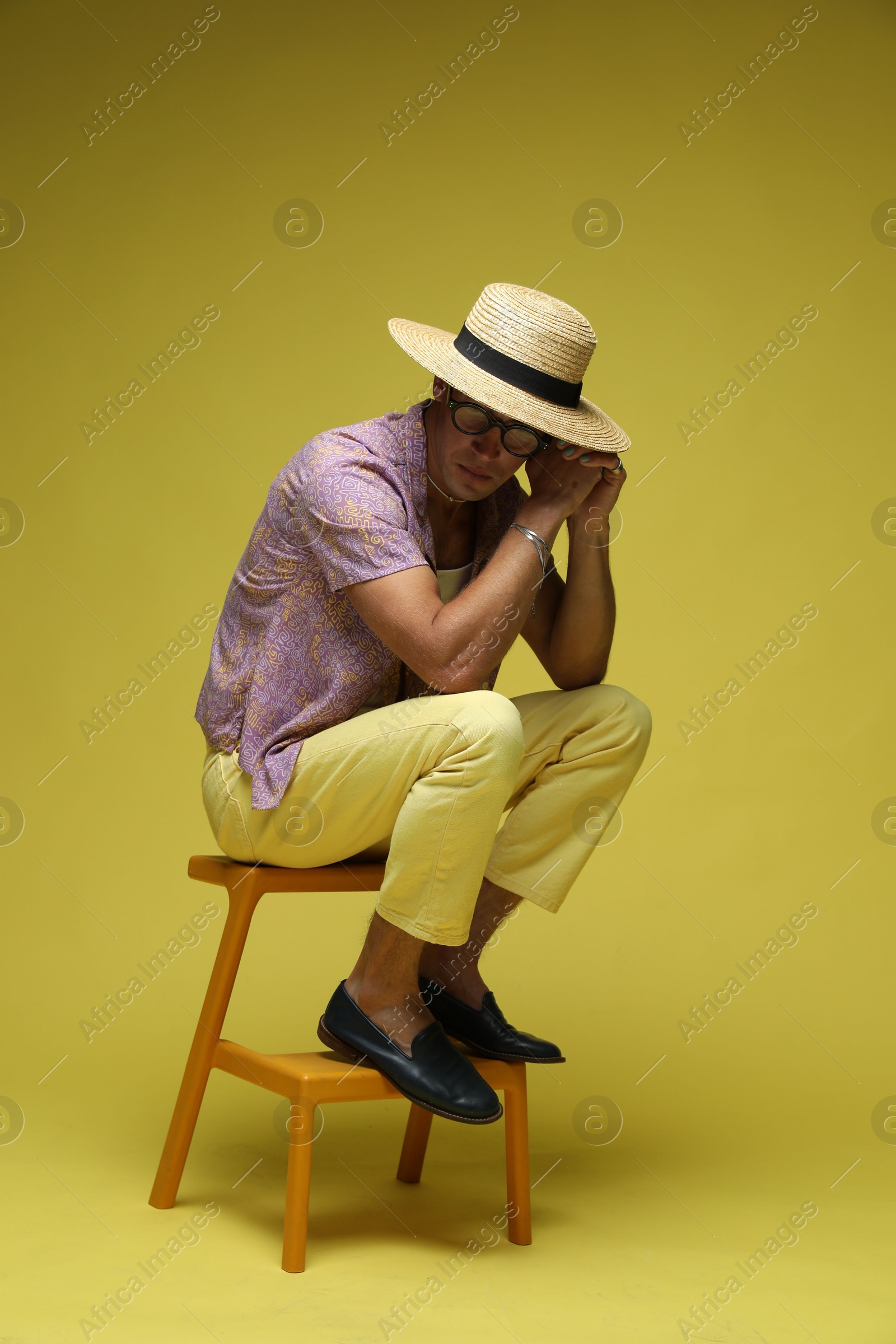 Fashionable portrait of handsome man in stylish outfit on color background Photo of Fashionable portrait of handsome man in stylish outfit on color background