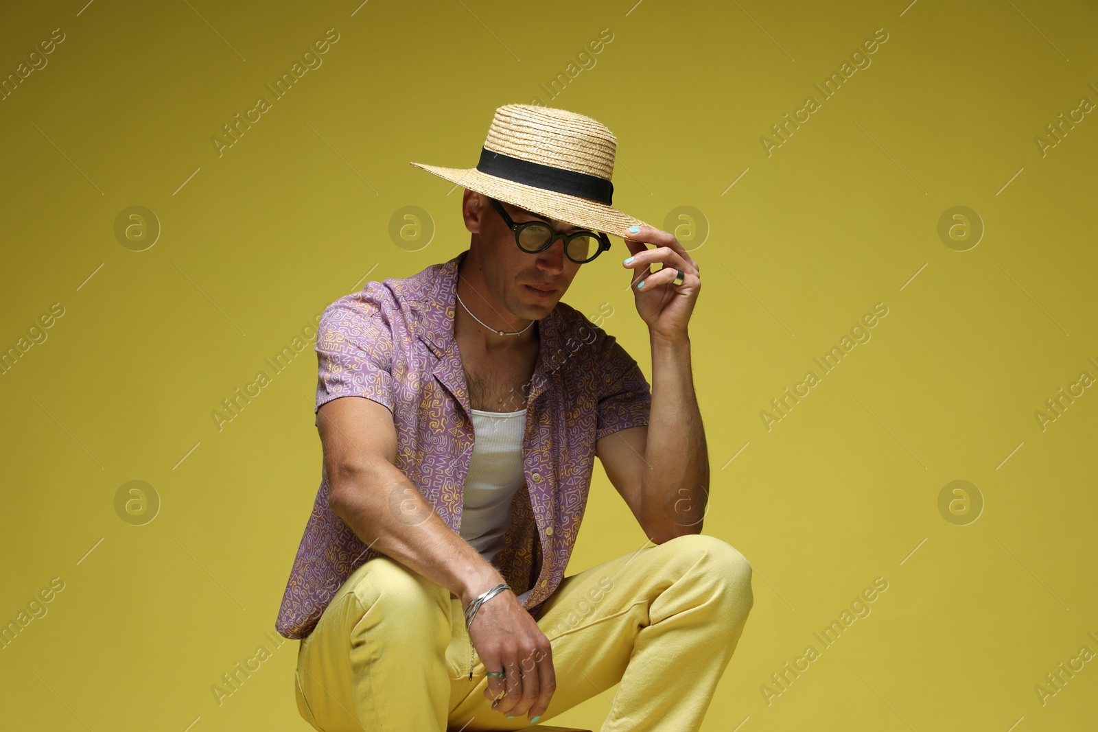 Fashionable portrait of handsome man in stylish outfit on color background Photo of Fashionable portrait of handsome man in stylish outfit on color background