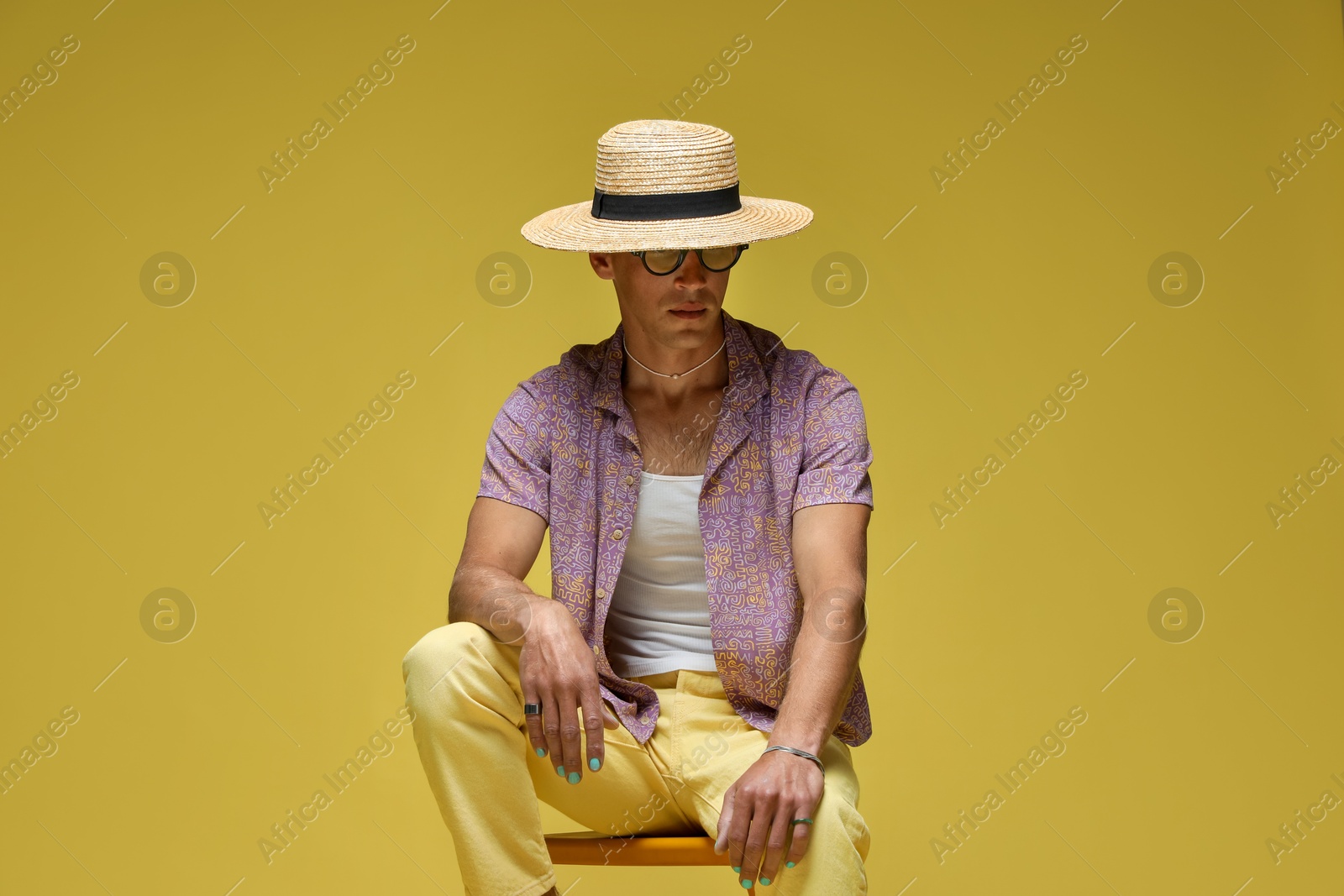 Fashionable portrait of handsome man in stylish outfit on color background Photo of Fashionable portrait of handsome man in stylish outfit on color background