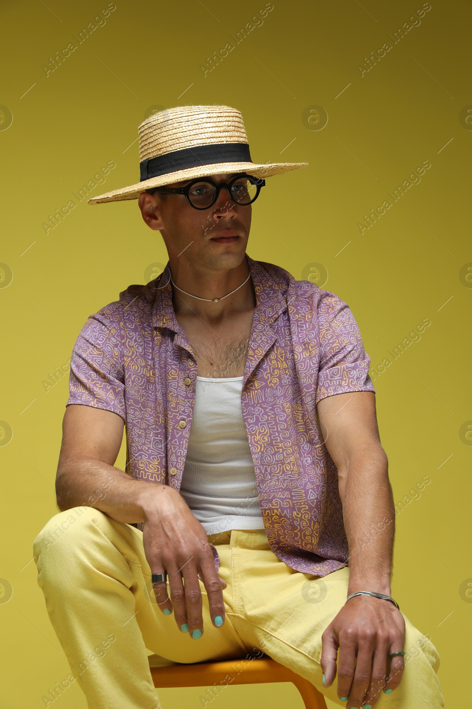 Fashionable portrait of handsome man in stylish outfit on color background Photo of Fashionable portrait of handsome man in stylish outfit on color background