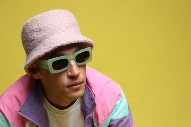 Photo of Fashionable portrait of handsome man in stylish outfit on color background, space for text