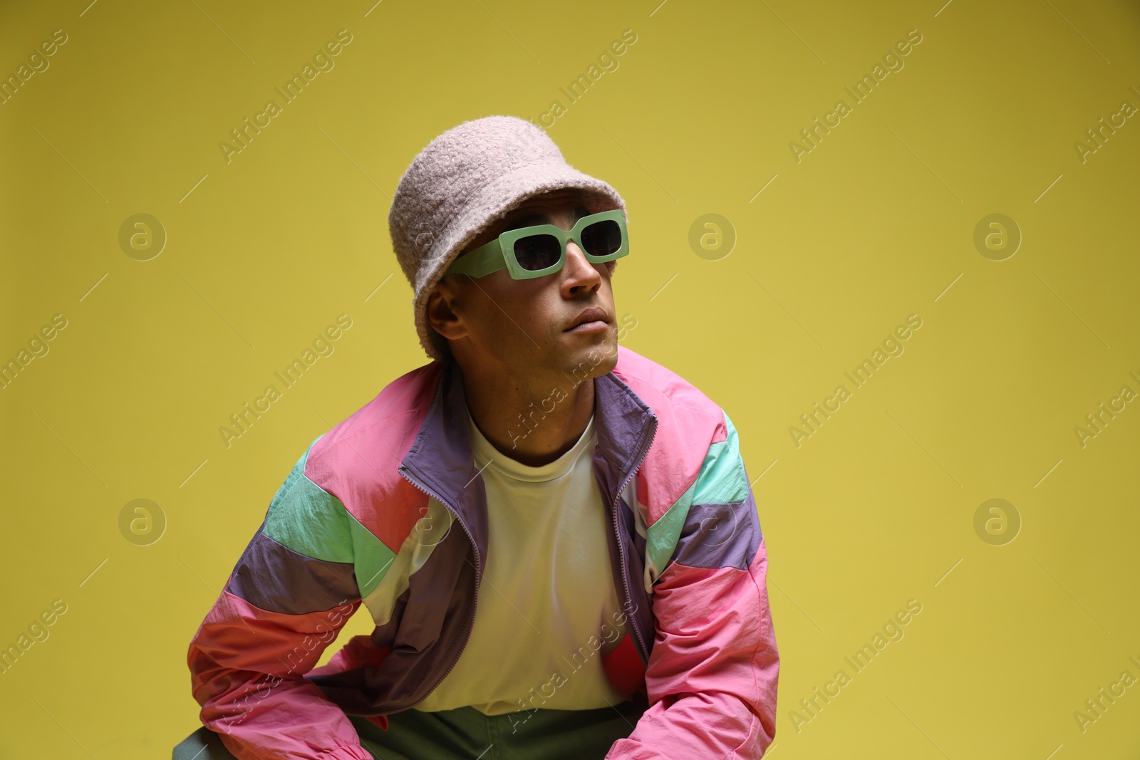 Fashionable portrait of handsome man in stylish outfit on color background, space for text Photo of Fashionable portrait of handsome man in stylish outfit on color background, space for text