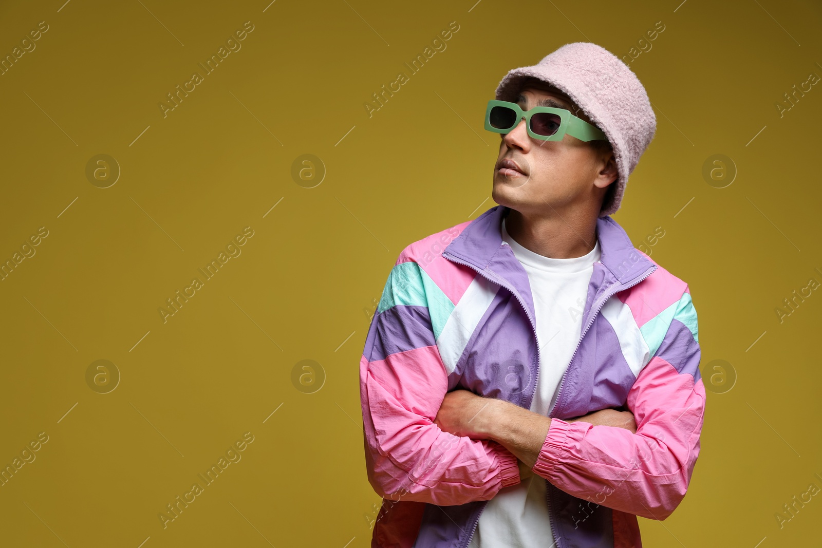 Fashionable portrait of handsome man in stylish outfit on olive background, space for text Photo of Fashionable portrait of handsome man in stylish outfit on olive background, space for text