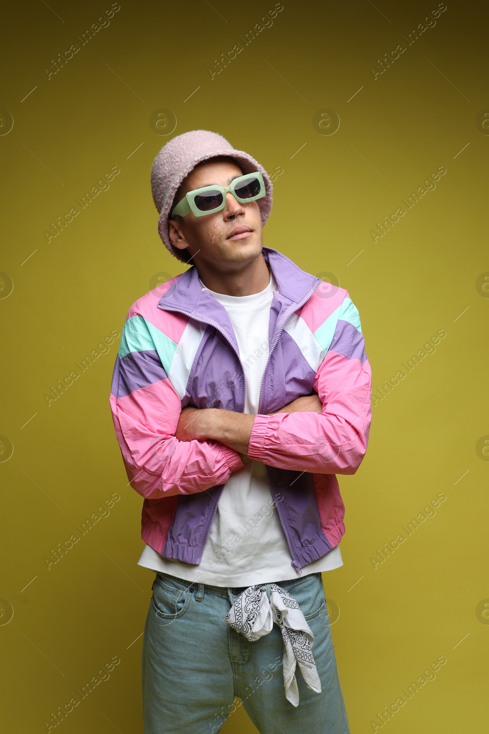 Fashionable portrait of handsome man in stylish outfit on olive background Photo of Fashionable portrait of handsome man in stylish outfit on olive background