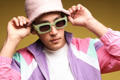Photo of Fashionable portrait of handsome man in stylish outfit on yellow background