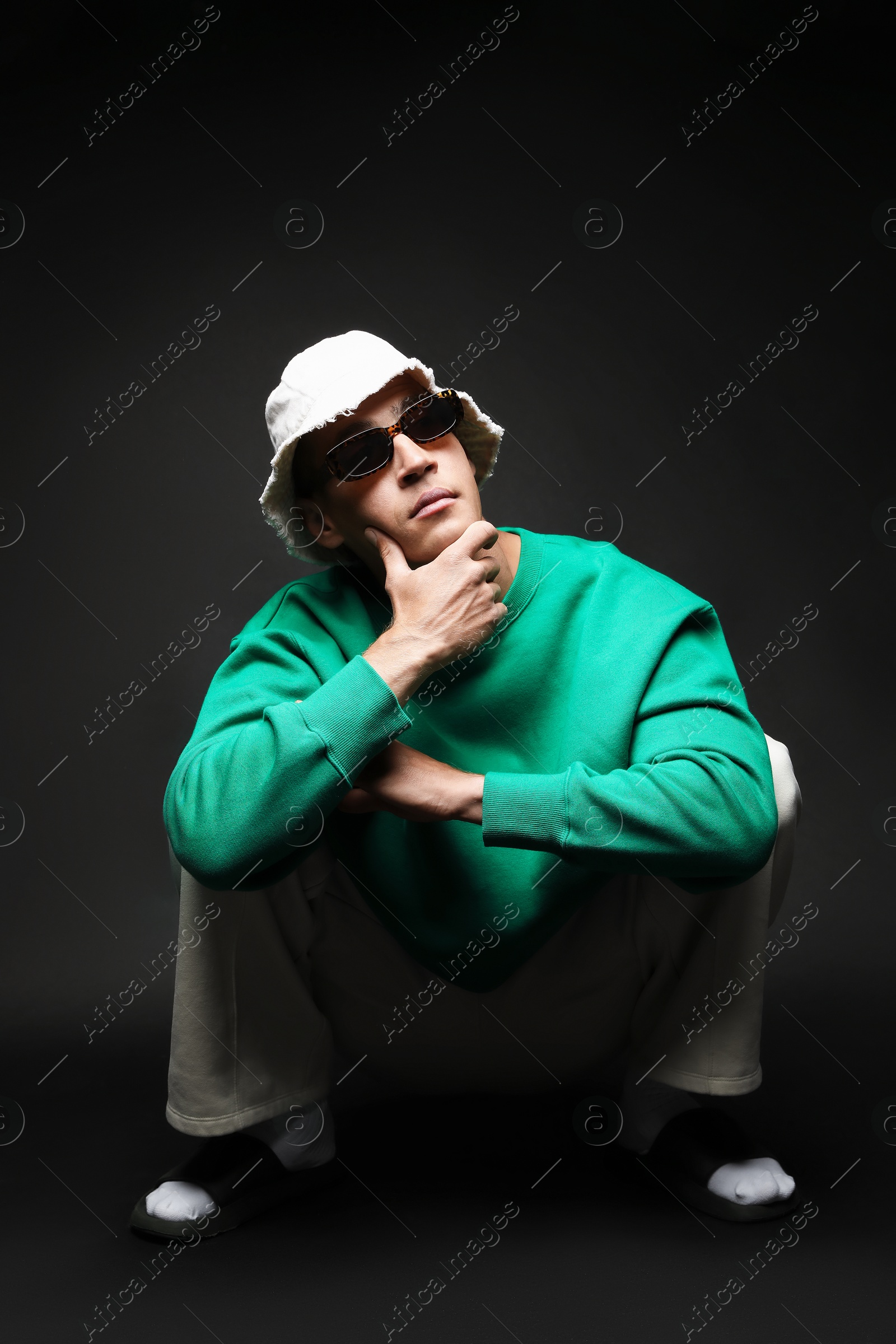 Fashionable portrait of handsome man in stylish outfit on black background Photo of Fashionable portrait of handsome man in stylish outfit on black background