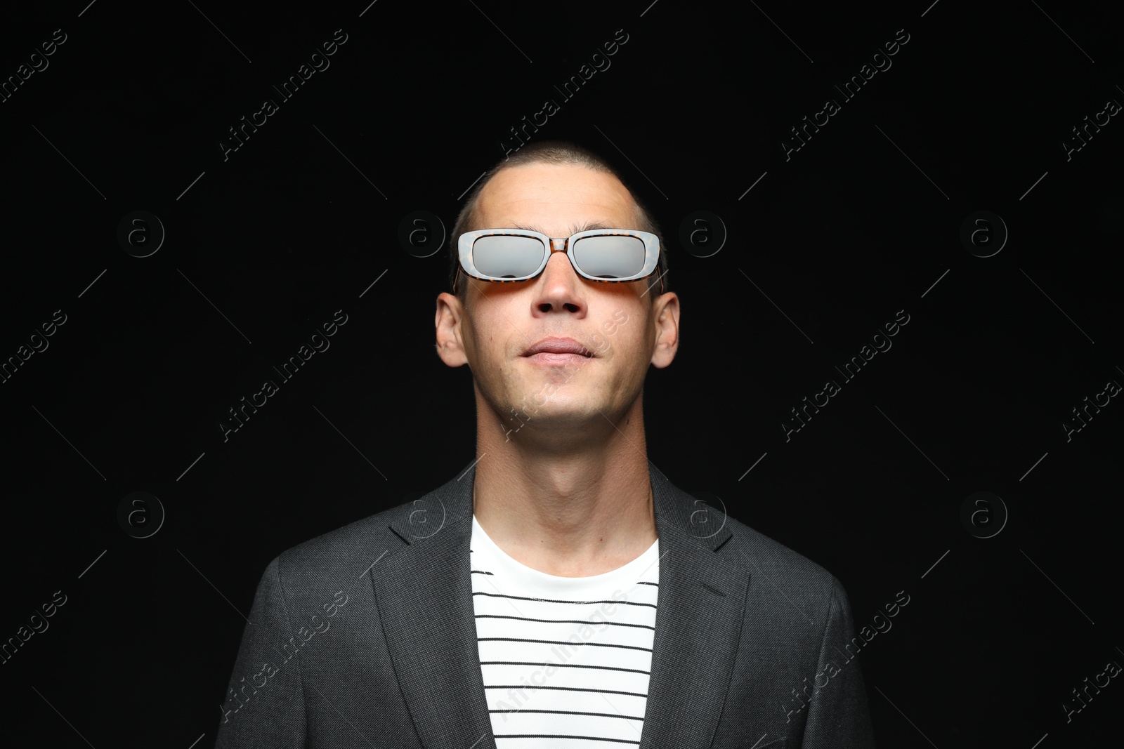 Fashionable portrait of handsome man in stylish outfit on black background Photo of Fashionable portrait of handsome man in stylish outfit on black background
