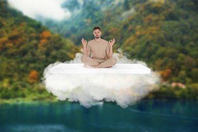 Image of Young man meditating on comfortable mattress as soft as cloud in air in mountains