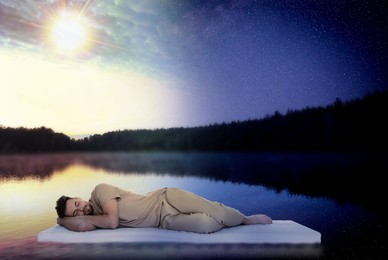 Image of Young man sleeping on comfortable mattress in river at evening