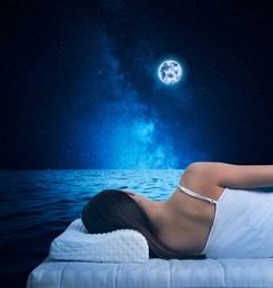 Image of Woman sleeping on comfortable mattress in sea at night