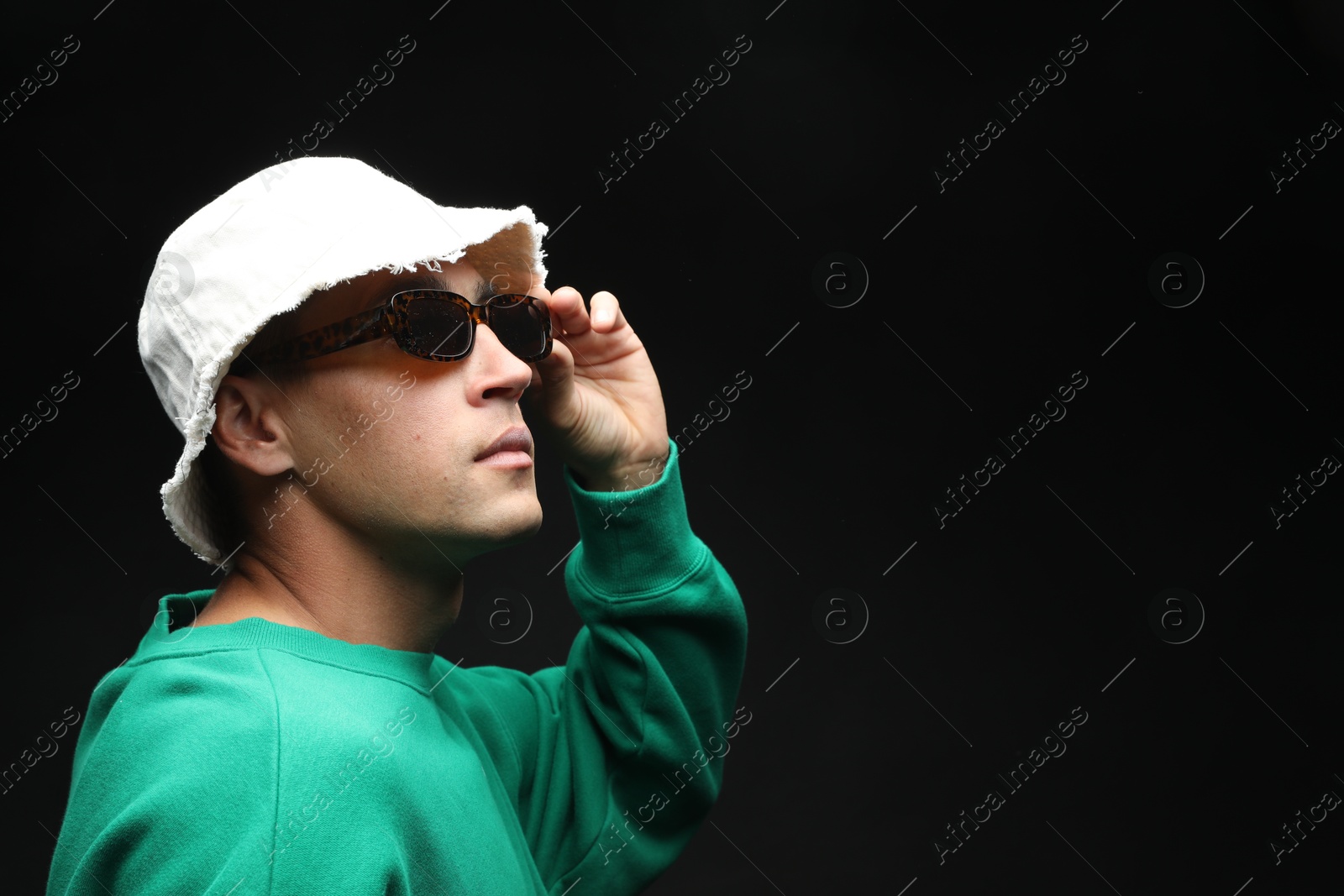 Fashionable portrait of handsome man in stylish outfit on black background, space for text Photo of Fashionable portrait of handsome man in stylish outfit on black background, space for text