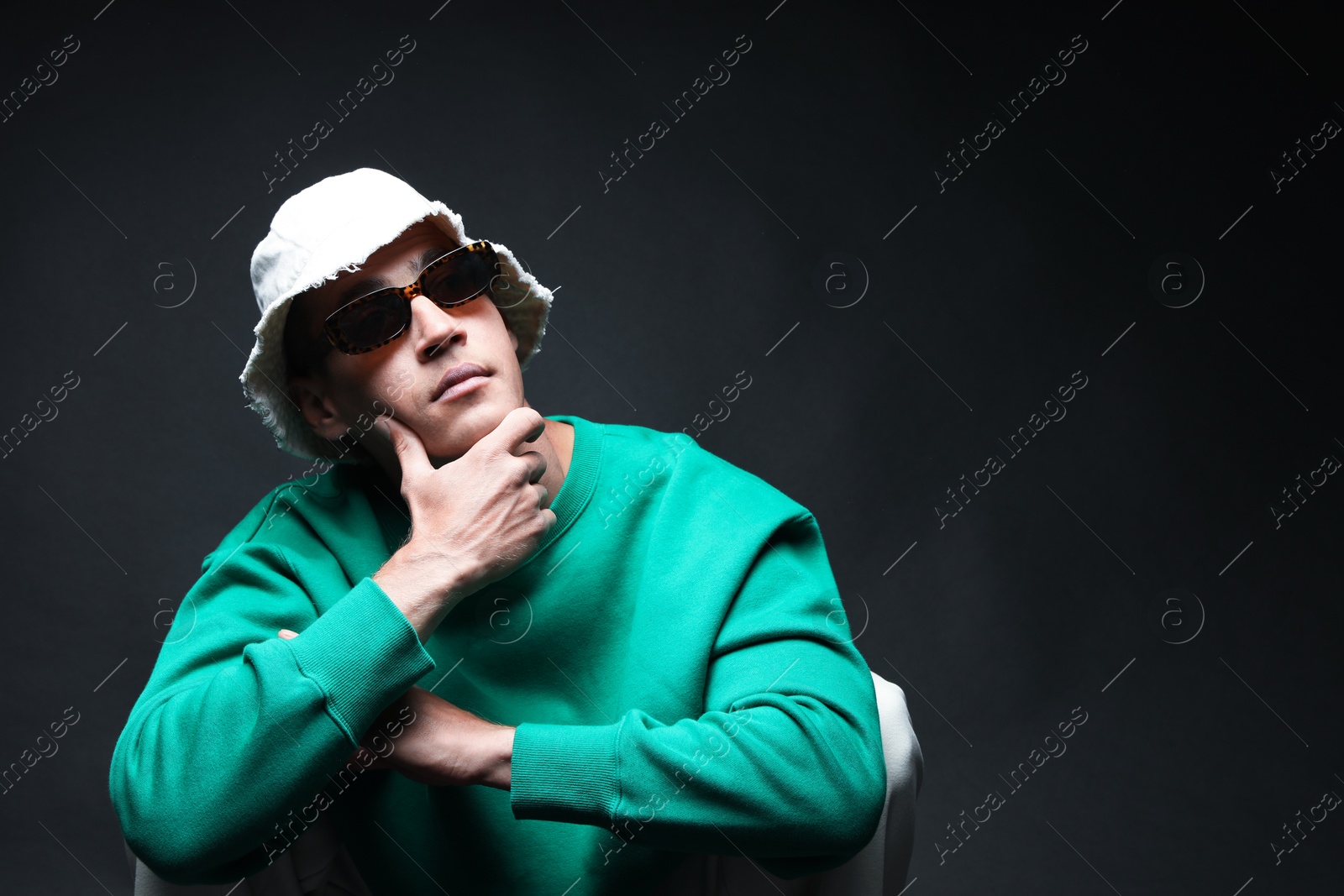 Fashionable portrait of handsome man in stylish outfit on black background, space for text Photo of Fashionable portrait of handsome man in stylish outfit on black background, space for text