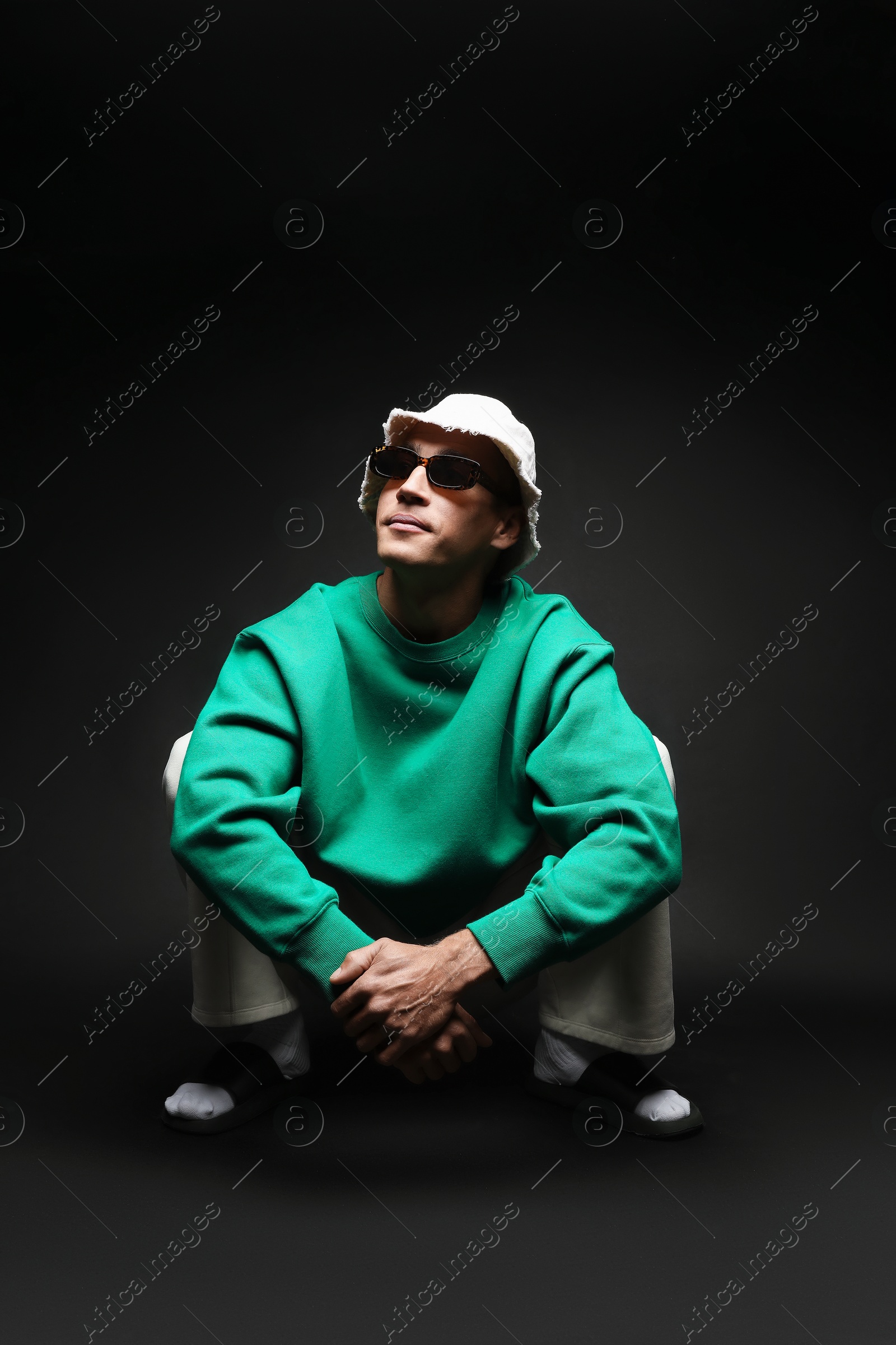 Fashionable portrait of handsome man in stylish outfit on black background Photo of Fashionable portrait of handsome man in stylish outfit on black background