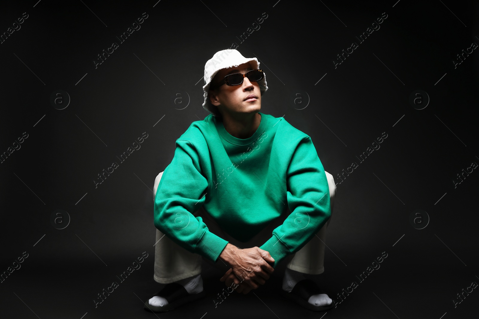 Fashionable portrait of handsome man in stylish outfit on black background Photo of Fashionable portrait of handsome man in stylish outfit on black background