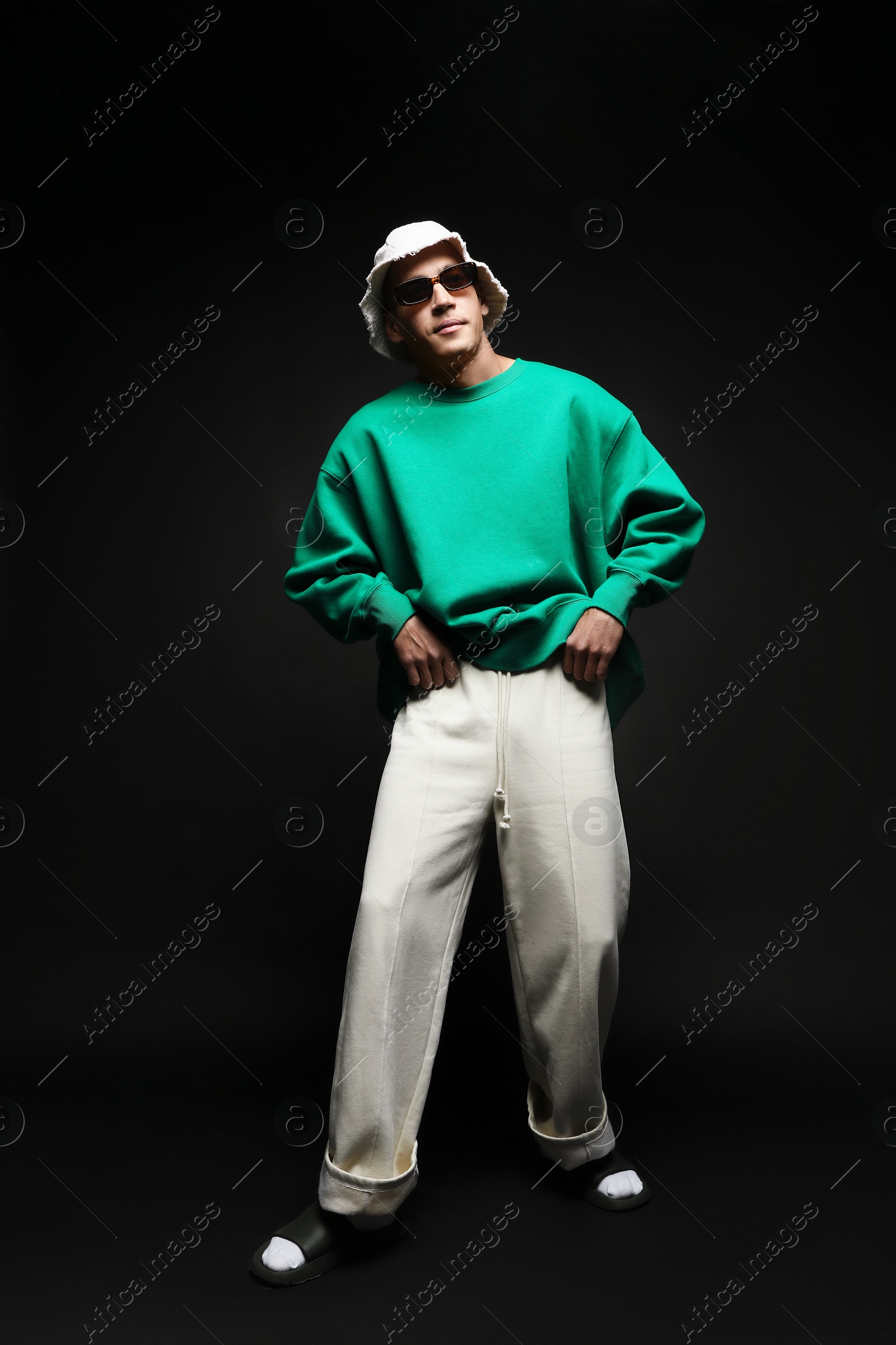 Fashionable portrait of handsome man in stylish outfit on black background Photo of Fashionable portrait of handsome man in stylish outfit on black background