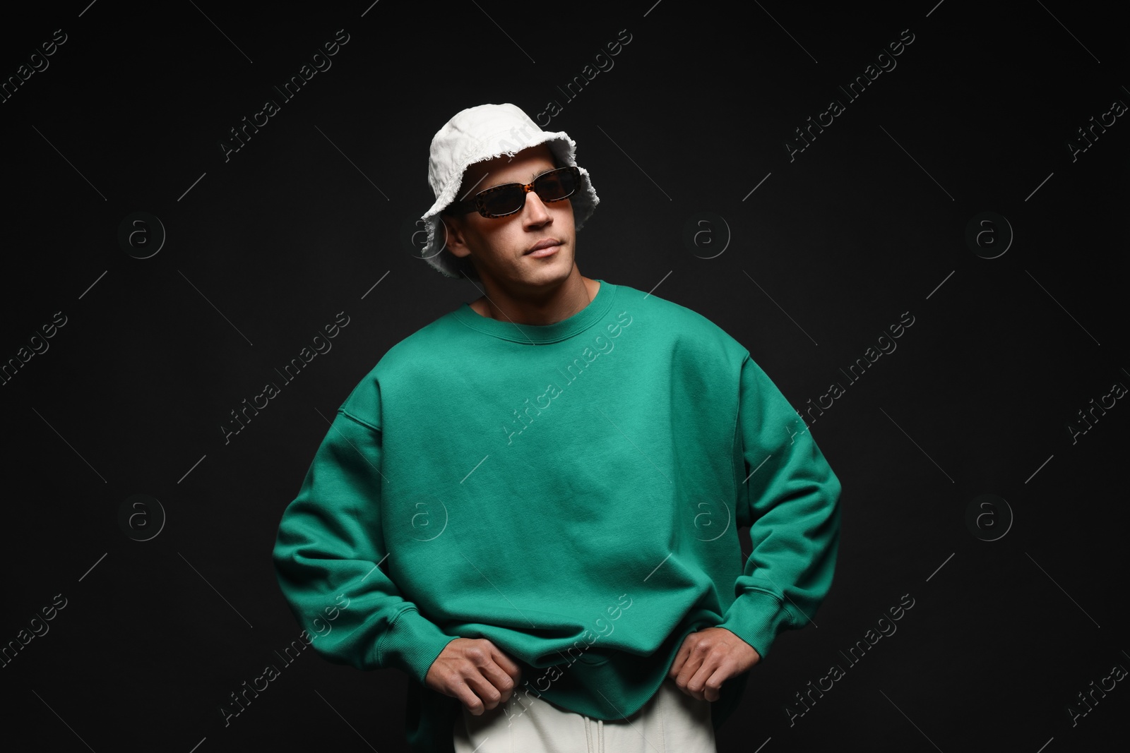 Fashionable portrait of handsome man in stylish outfit on black background Photo of Fashionable portrait of handsome man in stylish outfit on black background