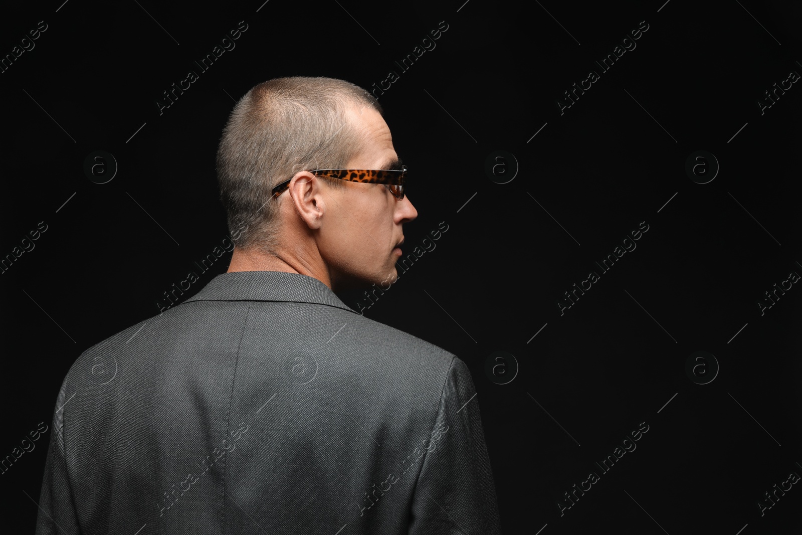 Fashionable portrait of handsome man in stylish outfit on black background, space for text Photo of Fashionable portrait of handsome man in stylish outfit on black background, space for text