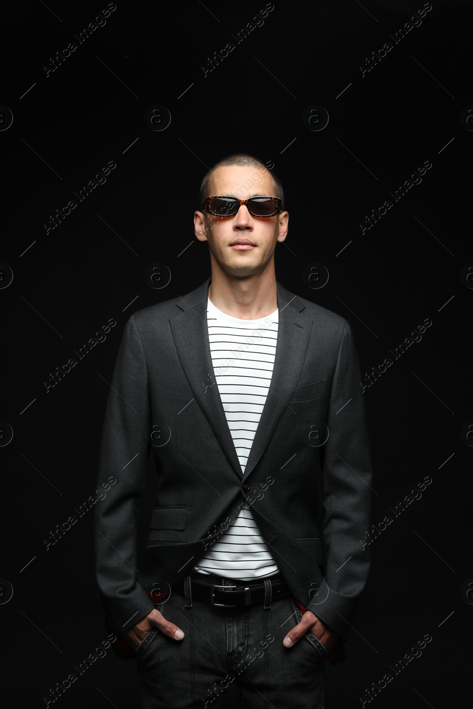 Fashionable portrait of handsome man in stylish outfit on black background Photo of Fashionable portrait of handsome man in stylish outfit on black background
