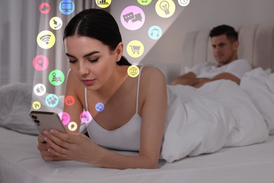 Image of Internet addicted woman using mobile phone instead of spending time with her boyfriend at home. Different icons flying out of device