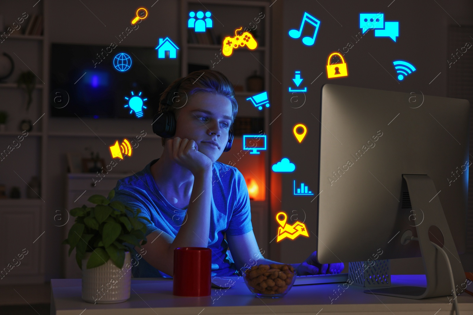 Internet addicted teenager using computer instead of sleeping at night. Different icons near him Image of Internet addicted teenager using computer instead of sleeping at night. Different icons near him