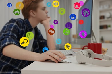 Image of Internet addicted teenager using computer in room. Different icons near him