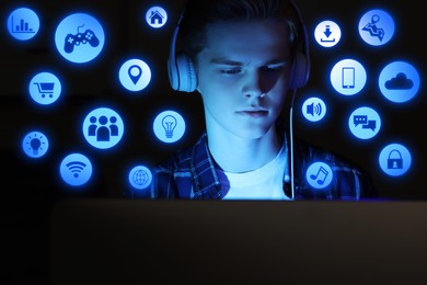 Image of Internet addicted teenager using computer instead of sleeping at night. Different icons near him