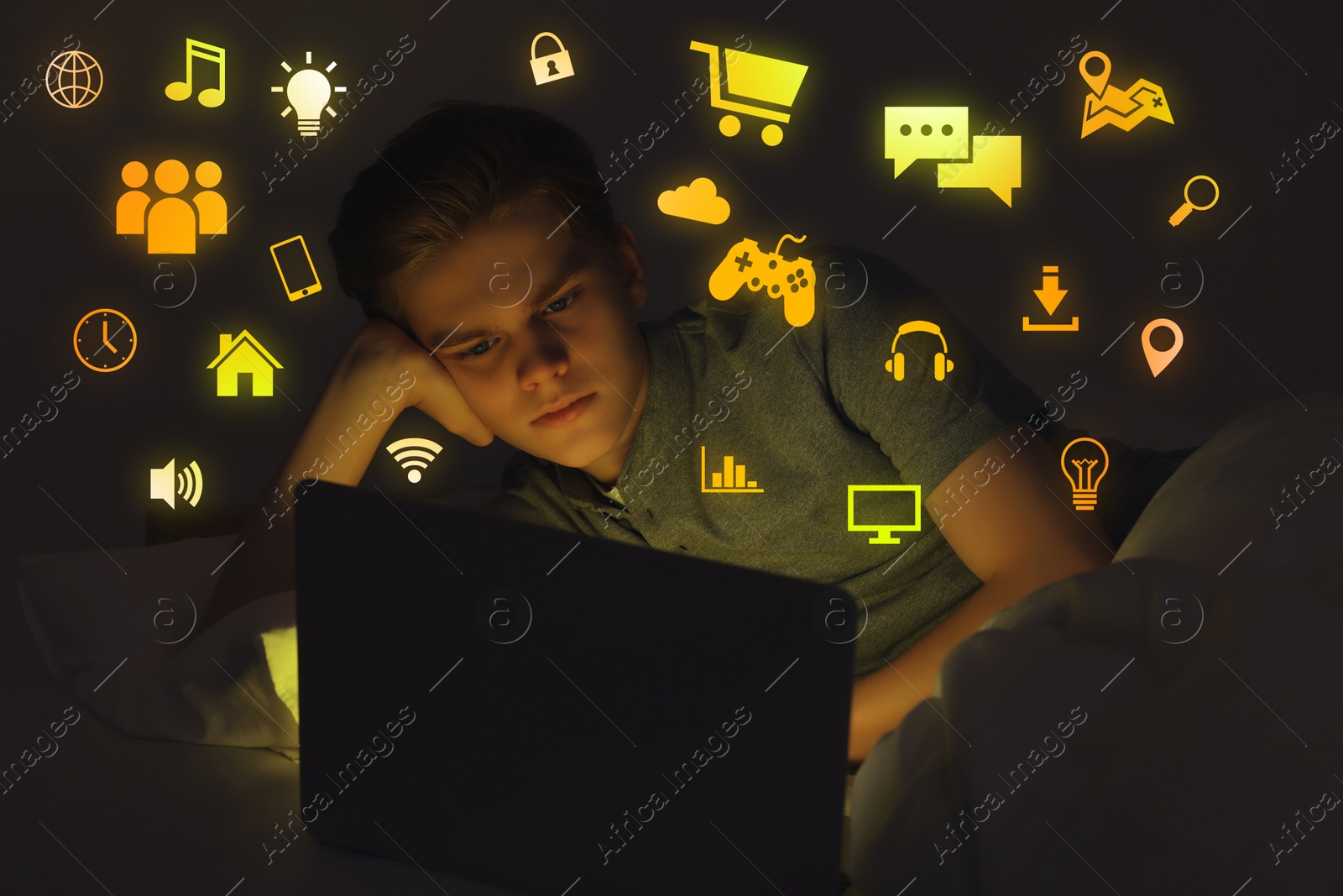 Internet addicted teenager using laptop instead of sleeping in bed at night. Different icons near him Image of Internet addicted teenager using laptop instead of sleeping in bed at night. Different icons near him