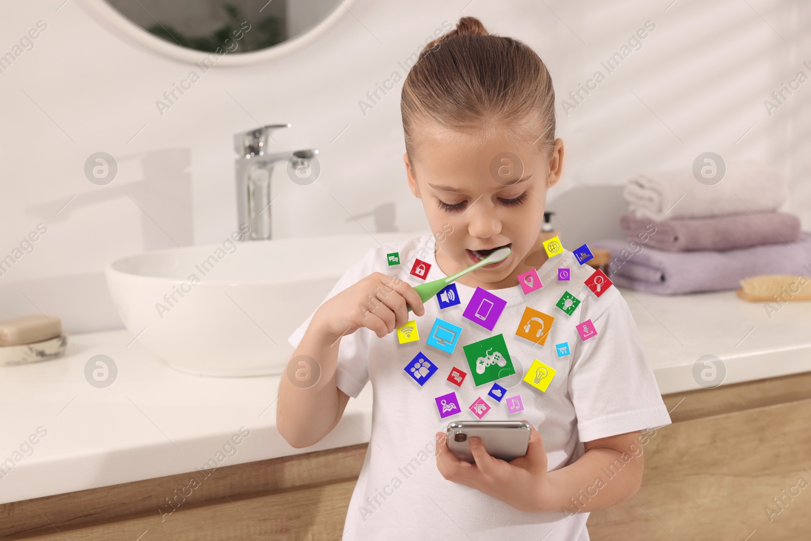 Internet addicted child using mobile phone while brushing teeth in bathroom. Different icons flying out of device Image of Internet addicted child using mobile phone while brushing teeth in bathroom. Different icons flying out of device