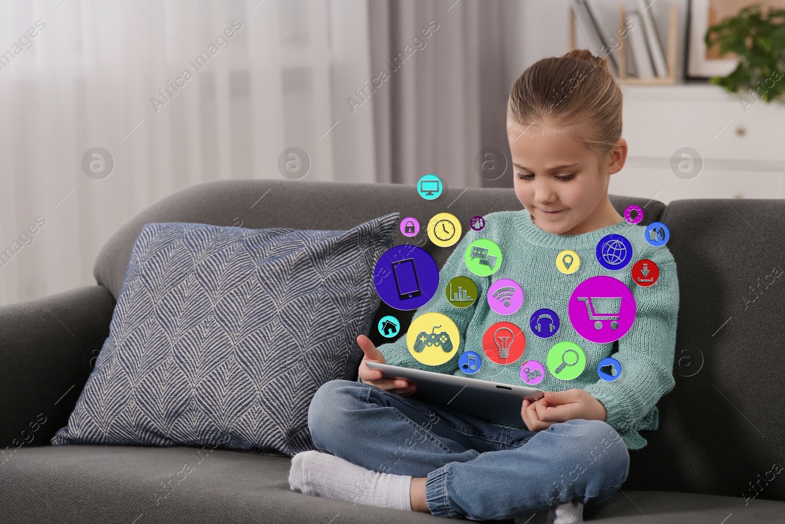 Internet addicted child using tablet computer at home. Different icons flying out of device Image of Internet addicted child using tablet computer at home. Different icons flying out of device