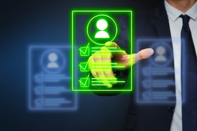 Image of Recruitment, employee search. Human resources manager choosing candidate's resume on virtual screen against dark blue background, closeup