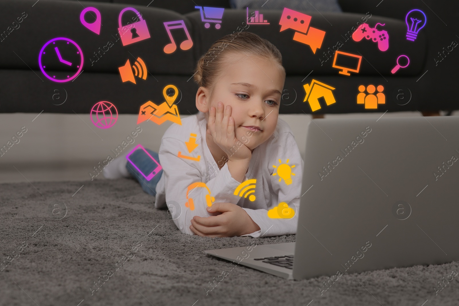 Internet addicted child using laptop on floor at home. Different icons flying out of computer Image of Internet addicted child using laptop on floor at home. Different icons flying out of computer