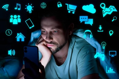 Image of Internet addicted man using mobile phone instead of sleeping at night. Different icons near him