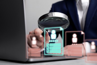 Image of Recruitment, employee search. Human resources manager with magnifying glass using laptop, closeup. Virtual resumes above computer