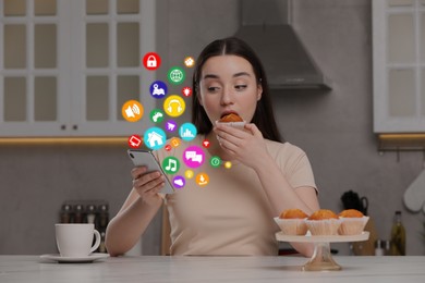Image of Internet addicted woman using mobile phone while eating at home. Different icons flying out of device