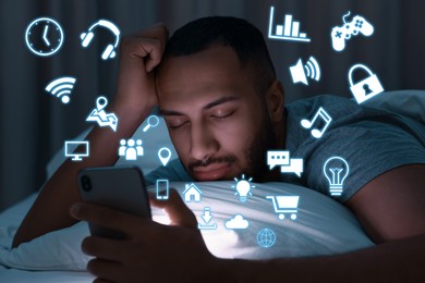 Image of Internet addicted man sleeping while holding mobile phone at night. Different icons flying out of device