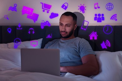 Image of Internet addicted man using laptop instead of sleeping at night. Different icons near him