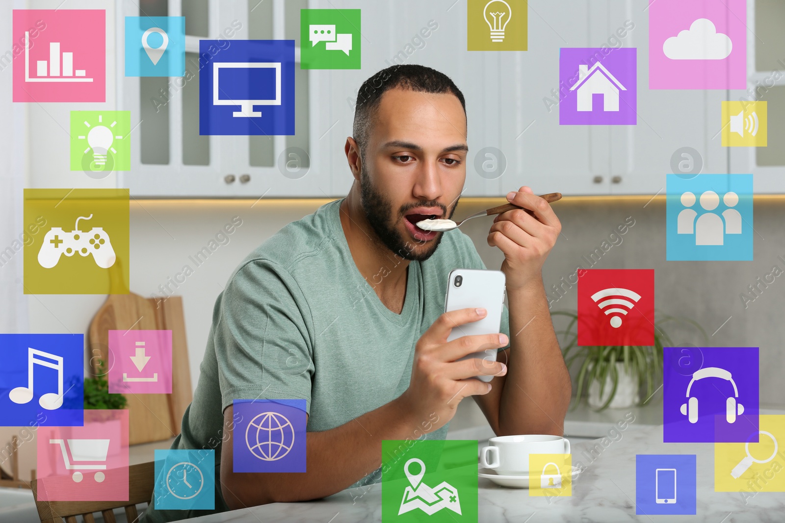 Internet addicted man using mobile phone while eating at home. Different icons around him Image of Internet addicted man using mobile phone while eating at home. Different icons around him