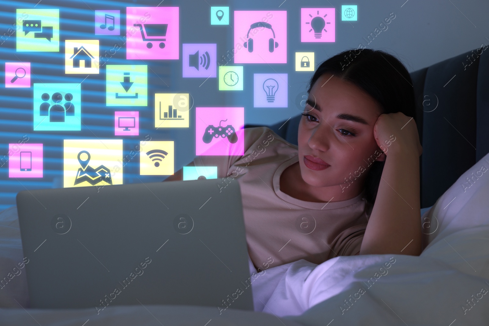 Image of Internet addicted woman using laptop instead of sleeping at night. Different icons near her