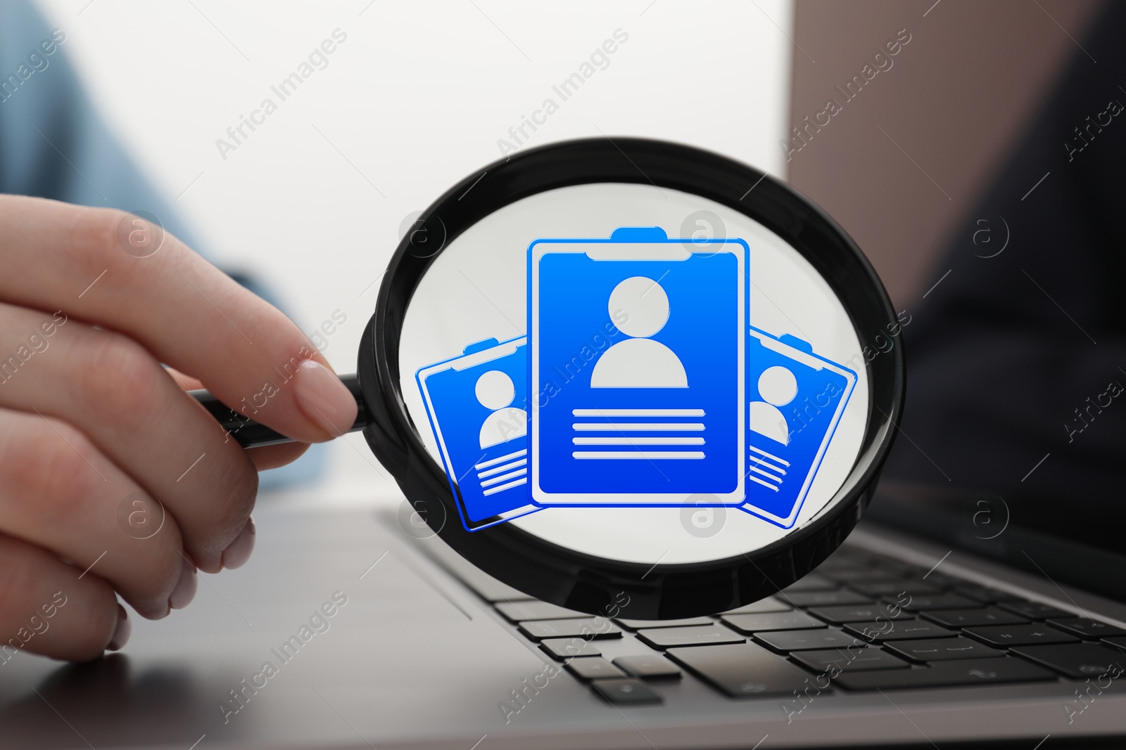 Recruitment, employee search. Human resources manager holding magnifying glass with virtual resumes inside, closeup Image of Recruitment, employee search. Human resources manager holding magnifying glass with virtual resumes inside, closeup