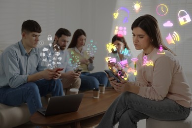 Image of Internet addicted friends using mobile phones instead of spending time together in room. Different icons flying out of devices