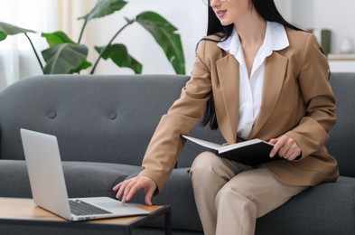 Photo of Professional psychologist working with laptop in office, closeup