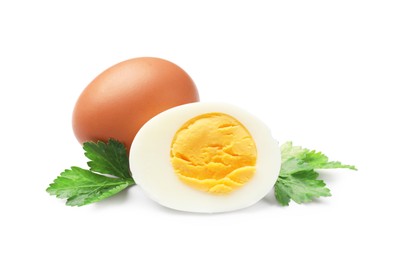 Photo of Boiled eggs and parsley on white background